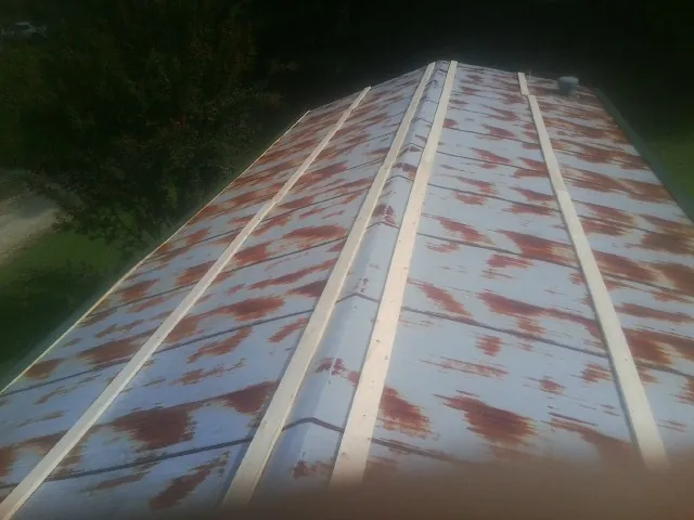 Rusted metal roof panels with new wood purlins before replacement — Storm Damage Roof Repair in Deshler by Roofing Brothers